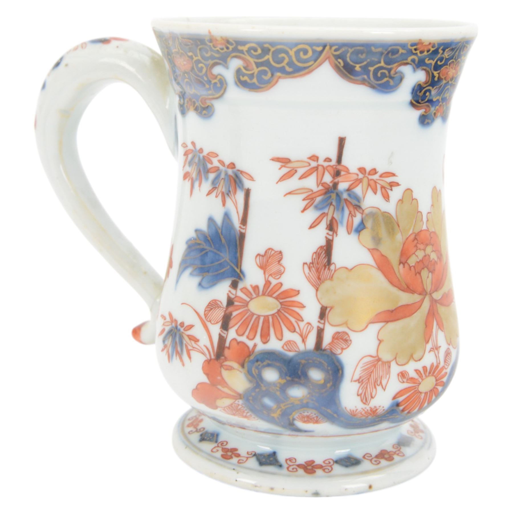 Pair of 18th century Chinese export tankards, each of bellied form with curved handle and circular foot, decorated in the Imari palette with peonies, chrysanthemums and bamboo, H12.5cm