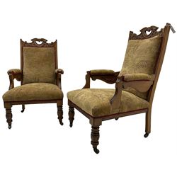 Pair of late Victorian oak salon open armchairs, pierced cresting rails carved with scrolling acanthus leaves, on turned feet with brass and ceramic castors