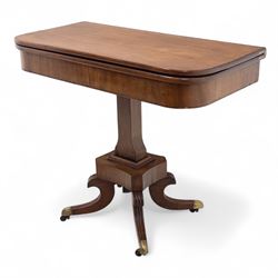 Regency mahogany fold-over table, hinged top with rounded corners opening to reveal a plain polished surface, supported on moulded pedestal base with reeded downswept legs, terminating in brass cups and castors (Extends to 90cm)