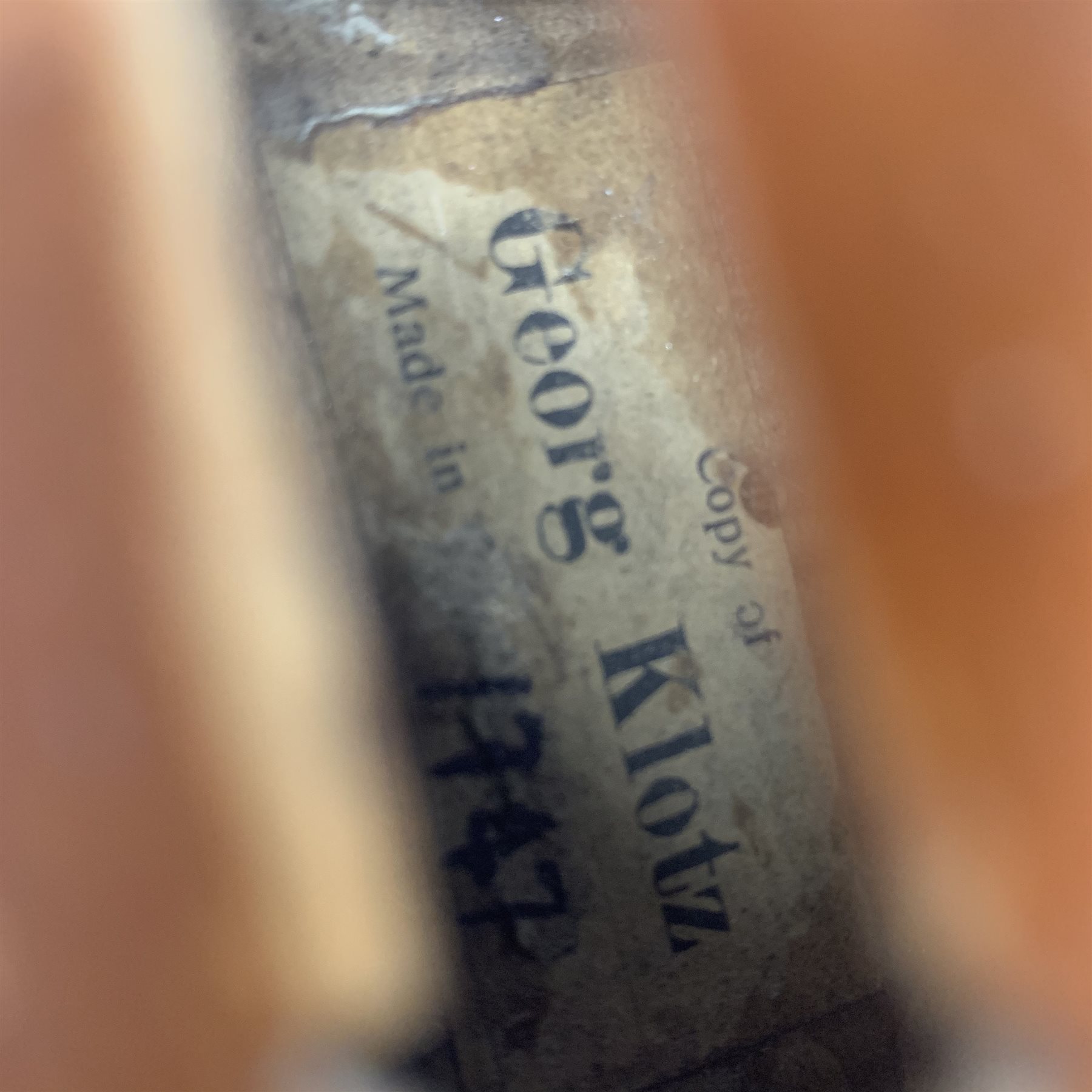  Late 19th century violin with 36cm maple back and spruce top, bears label 'Copy George Klotz Made in 1747', L59cm overall, in ebonised wooden carrying case with two bows  