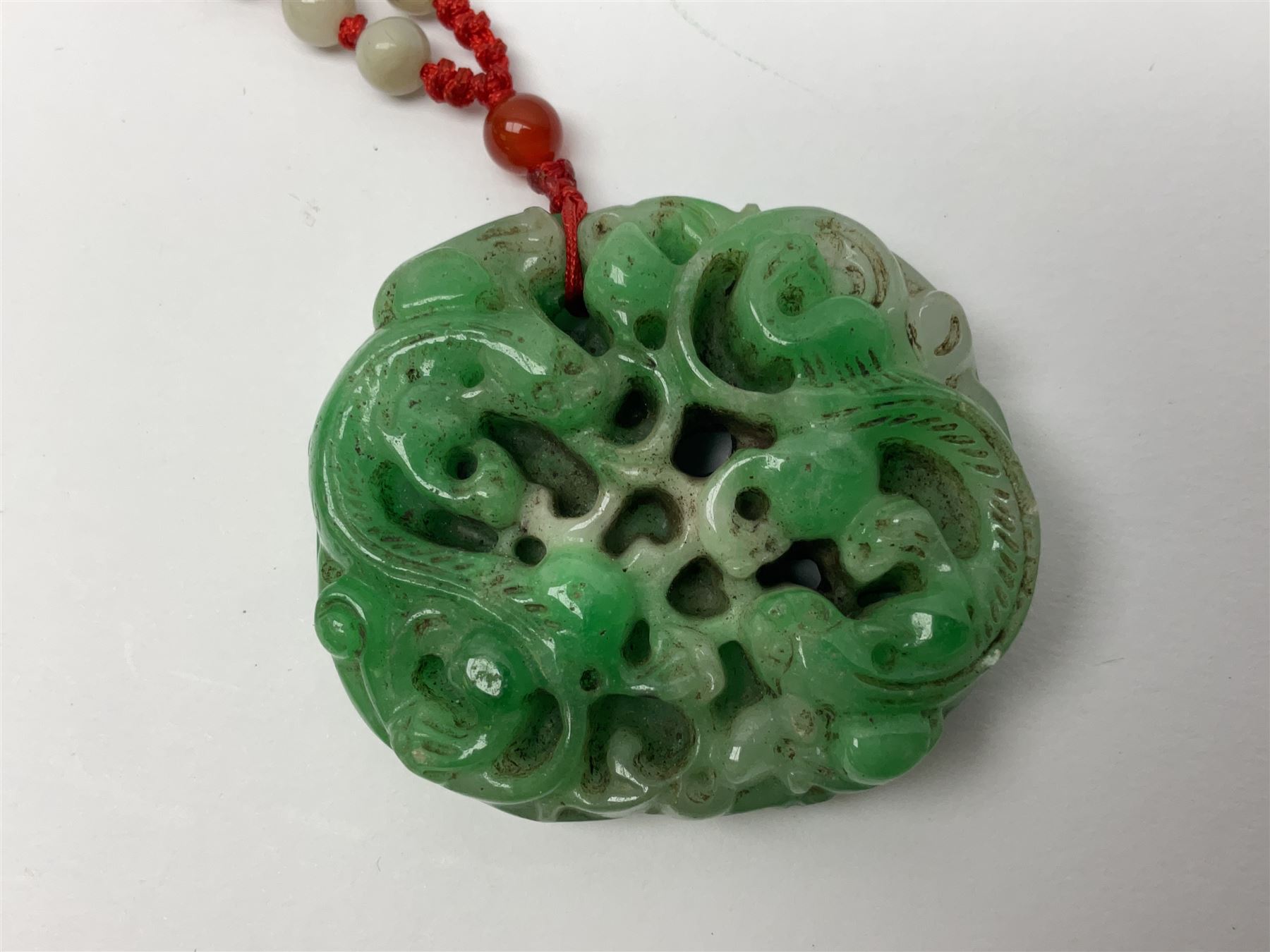 Chinese hardstone carving of a fish amongst coral, with platted rope handle, together with other hardstone and soft stone carvings  