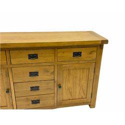 Light oak sideboard, fitted with six drawers and two cupboards 