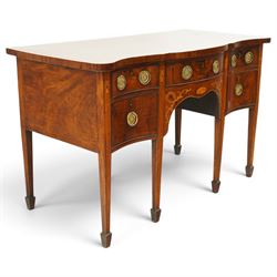 George III inlaid mahogany serpentine sideboard, the shaped top with crossbanding and satinwood stringing, fitted with central bow-front cock-beaded frieze drawer over a shaped apron inlaid with paterae, shell motifs and scrolling foliage, flanked by a deep right-hand drawer and two drawers to the left, raised on square tapering supports with spade feet