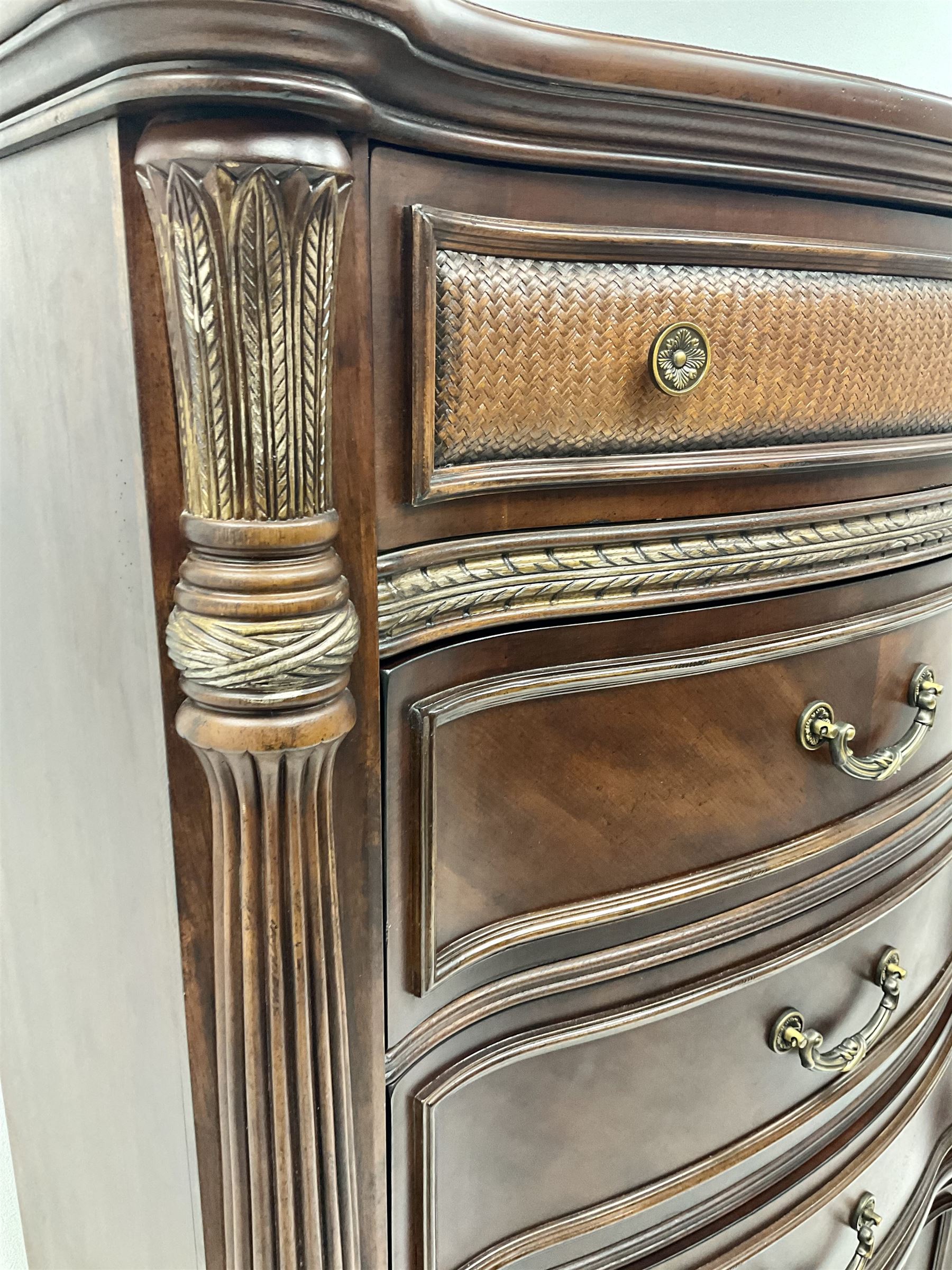 Kevin Charles American walnut serpentine chest, five graduating drawers, half turned fluted column carving, turned supports 