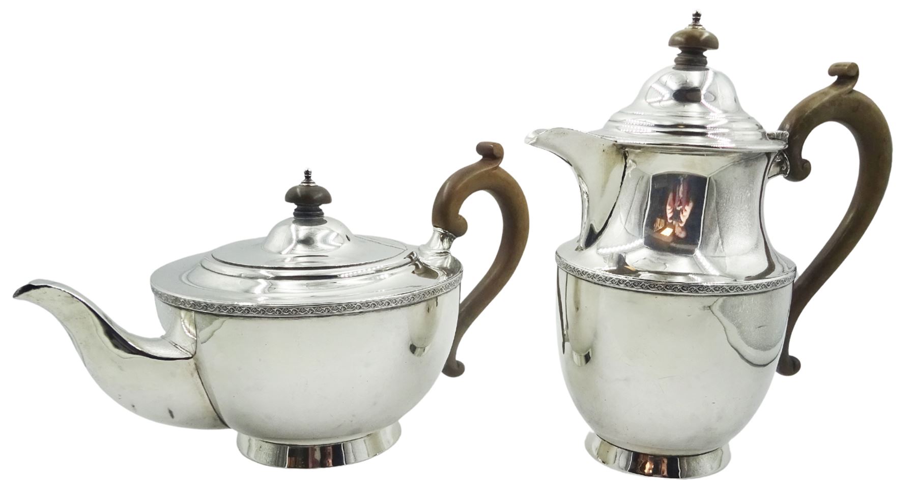 1920's silver teapot and hot water pot, each with foliate scroll band