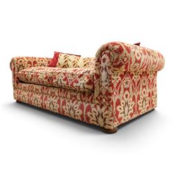 Tetrad - grande two seat 'Elgar' sofa of traditional Chesterfield shape with rolled arms, upholstered in red and gold foliate patterned fabric with matching loose and scatter cushions, on compressed bun feet