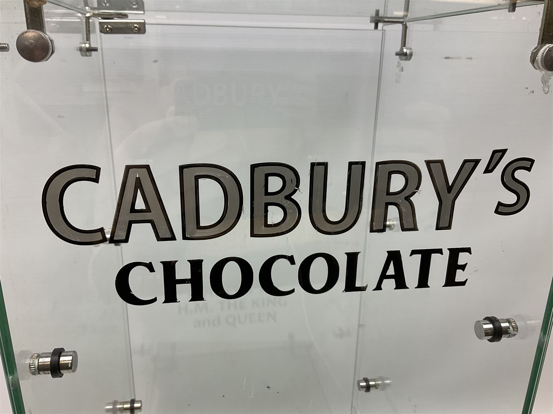 Cadbury's chocolate countertop display advertising cabinet, glazed with 'Cadbury's Makers to T.M The King & Queen', with two glass shelves and a back opening door, H54,5cm