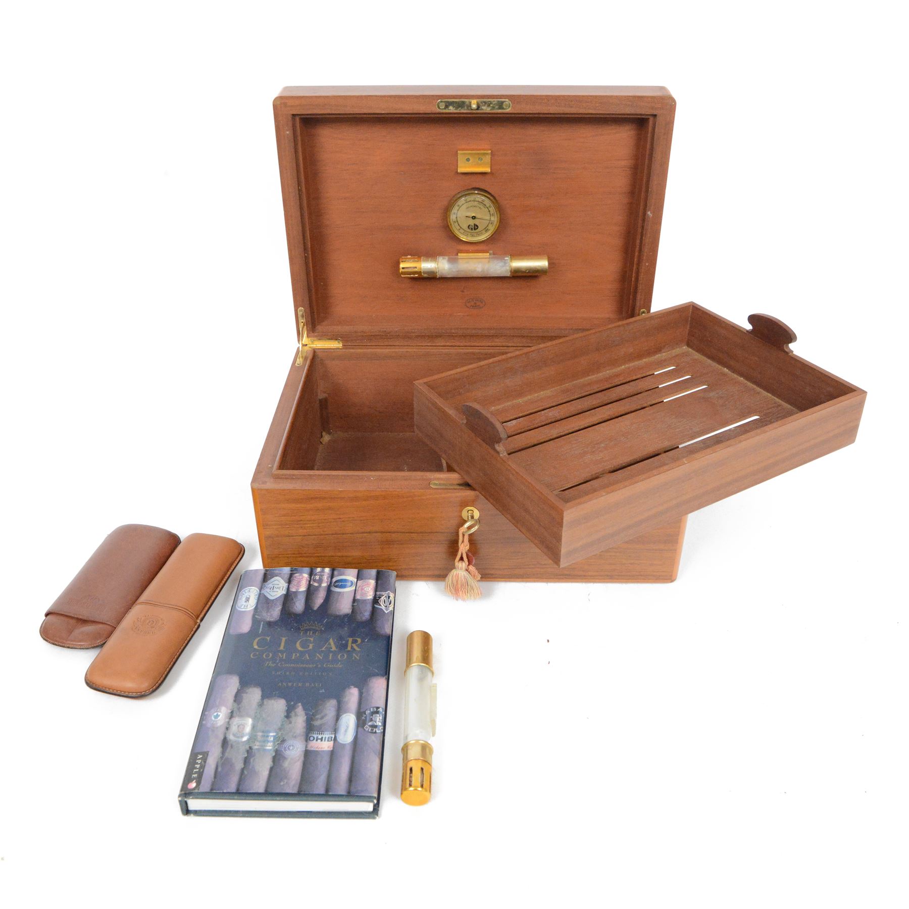 Elie Bleu of Paris, mahogany humidor with partitioned interior and inset hygrometer, together with two cigar cases and The Cigar Companion book