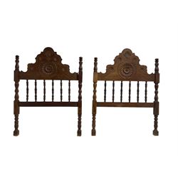 Pair Spanish stained beech single 3' bedsteads, spindle turned backs and carved with scrolling floral decoration 