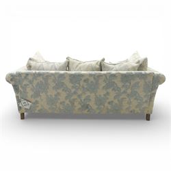 Alstons - 'Lowry' three seater settee, loose cushioned back and seat with additional cushions upholstered in silver and blue floral fabric, supported on square feet with chrome castors to the front
