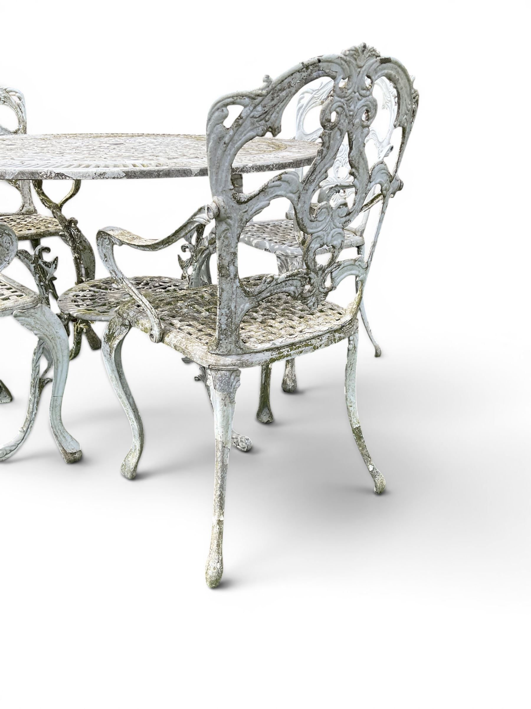 Victorian style cast aluminium white painted garden table and four armchairs chairs with S-scroll acanthus leaf pierced backs over lattice seats
