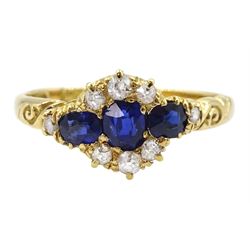 Victorian 18ct gold sapphire and diamond cluster ring, with engraved scroll design shoulders, Birmingham 1896