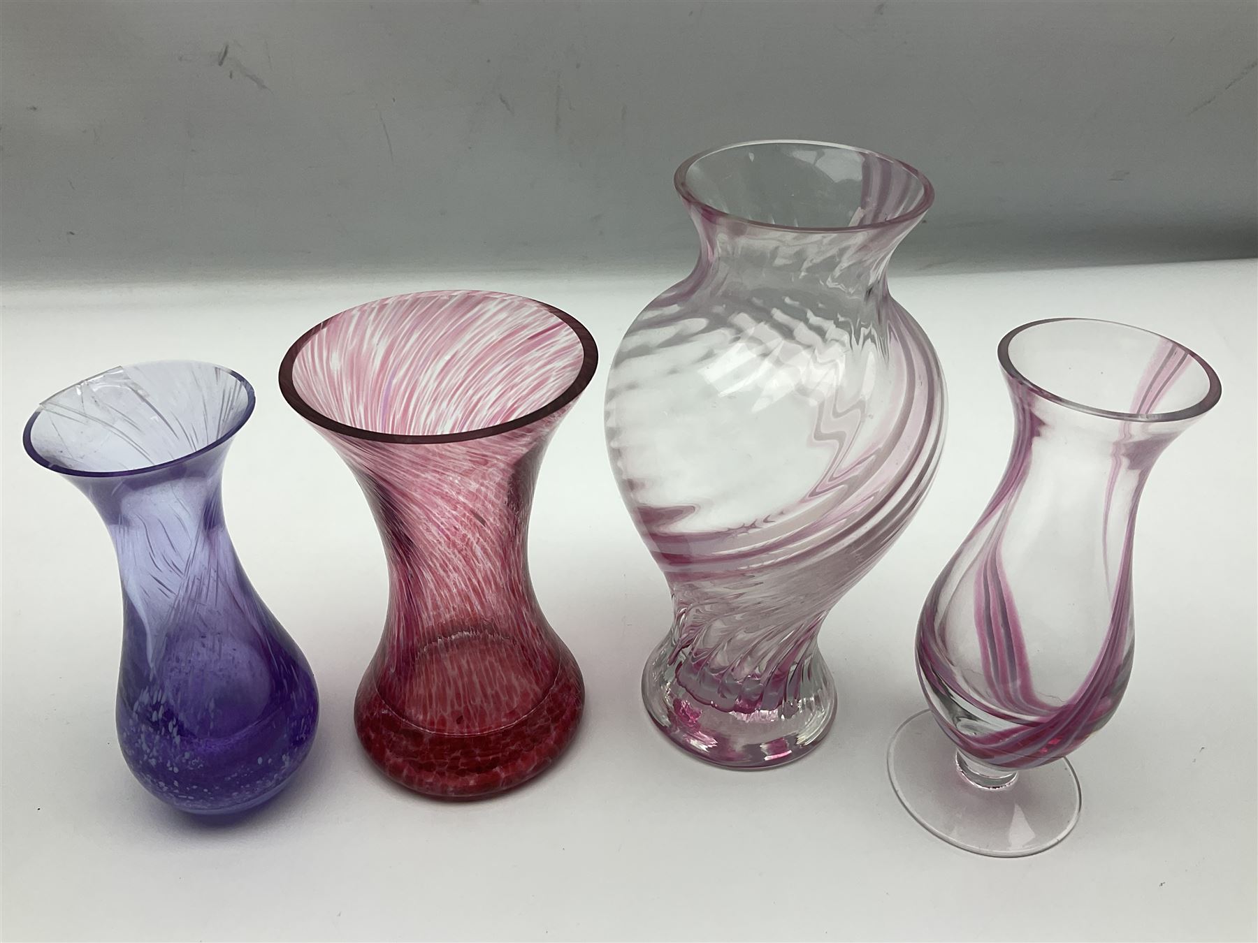 Collection of pink/purple Caithness glass vases, to include mottled and swirl designs, largest 20cm (19)