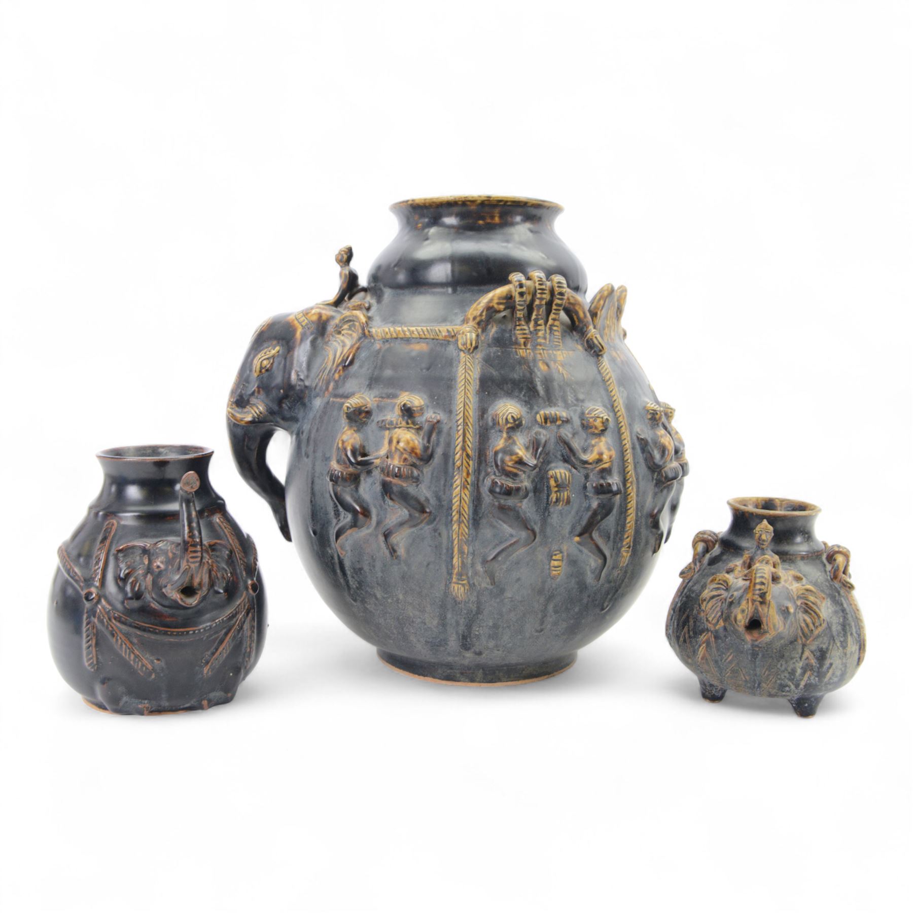 Large Thai vase decorated with relief figures and elephants, together with two smaller examples