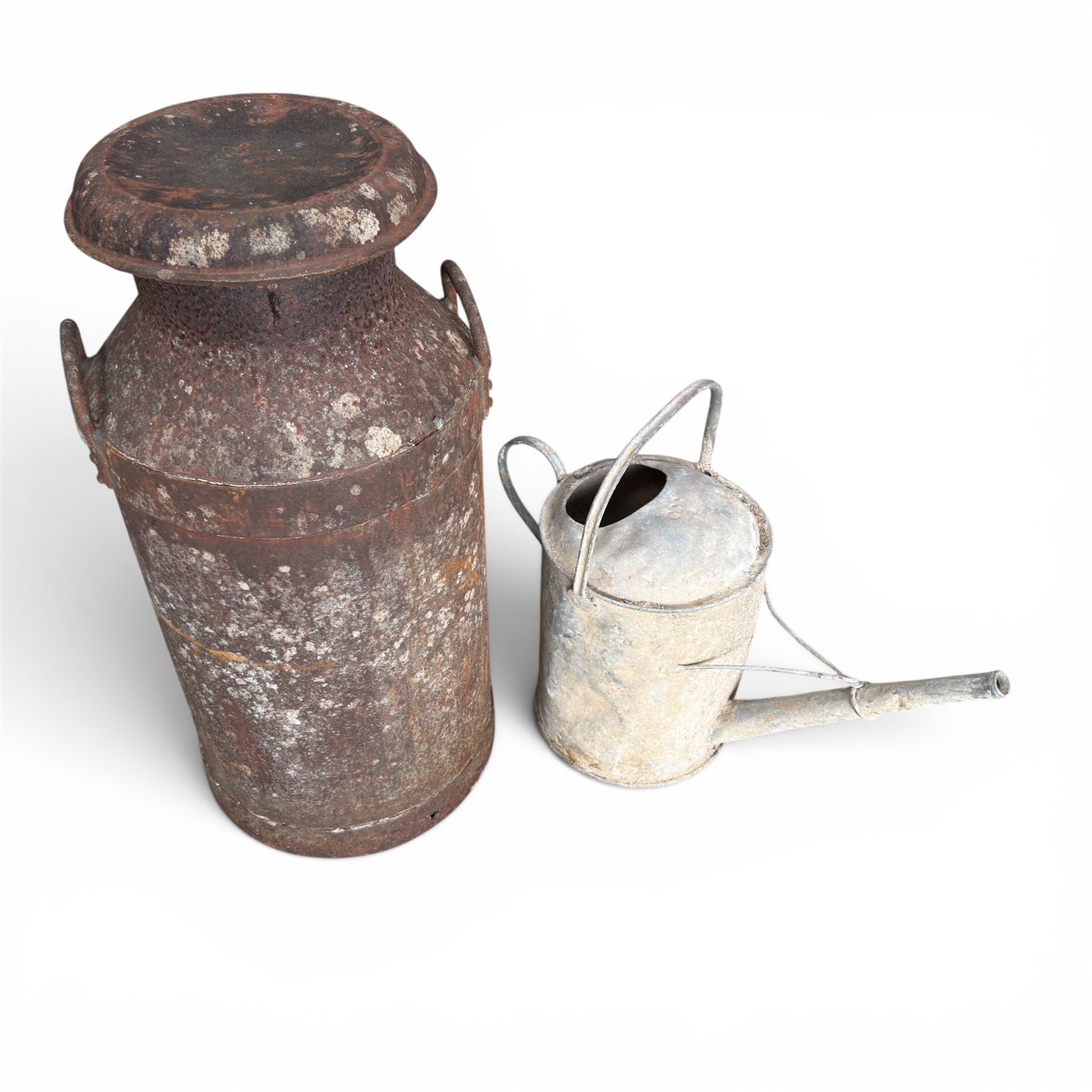 19th century milk churn with weathered patina along with aluminium watering can