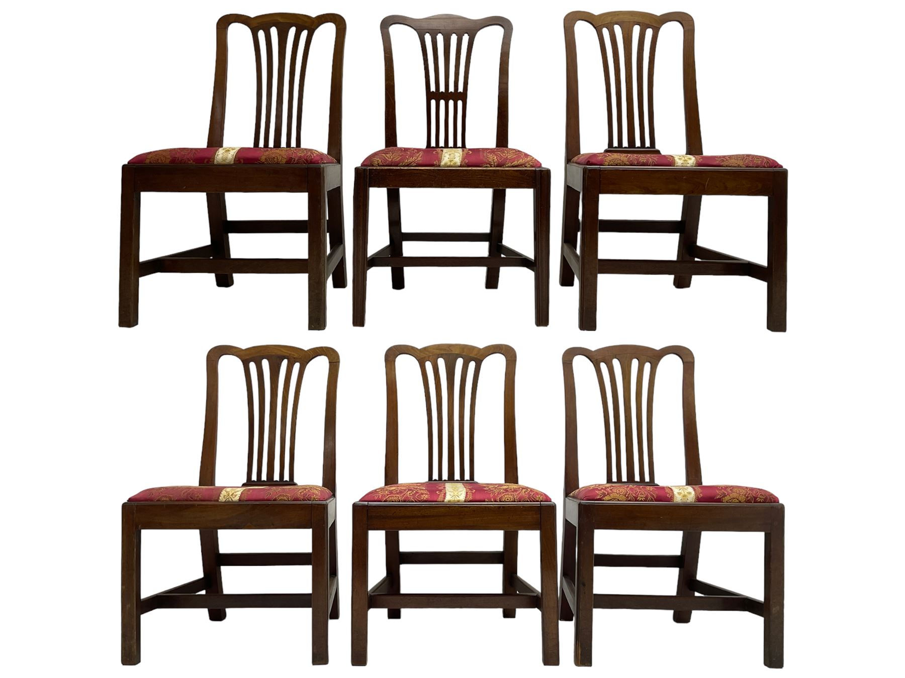 Set of six (5+1) George III mahogany dining chairs, shaped cresting rail over pierced and flared splat, drop-in seat upholstered in crimson and ivory floral patterned fabric, raised on chamfered square supports united by H-stretcher