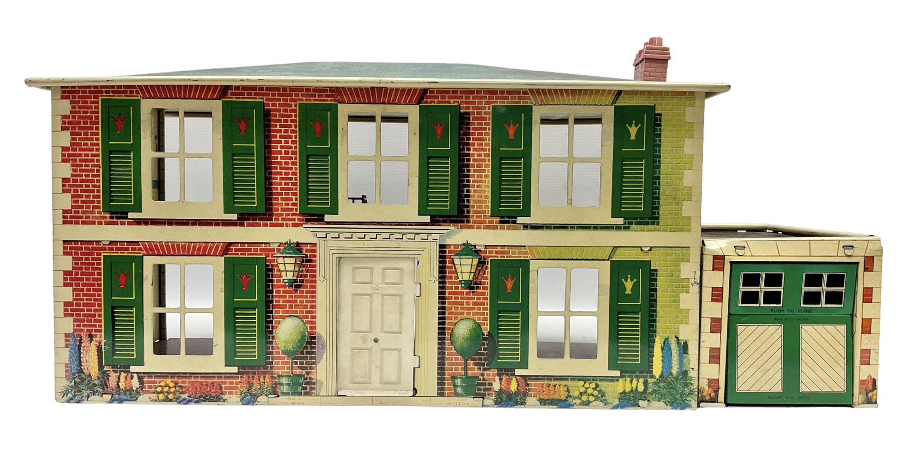 Mid-20th century Mettoy tin-plate double-fronted two-storey doll's house, the front elevation with five unglazed windows flanked by green shutters, central opening door, open back giving access to five rooms together with an attached garage, 60cm wide