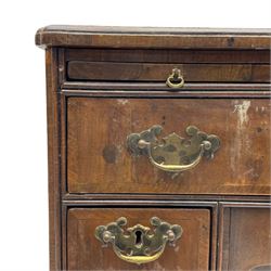Georgian walnut kneehole desk, moulded rectangular top with book-matched veneers within crossbanding, fitted with slide over one long drawer, frieze drawer, six small drawers and recessed cupboard, raised on bracket feet