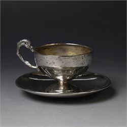German silver cup and saucer, both with engraved foliate decoration, stamped 800, the saucer with crescent and crown mark