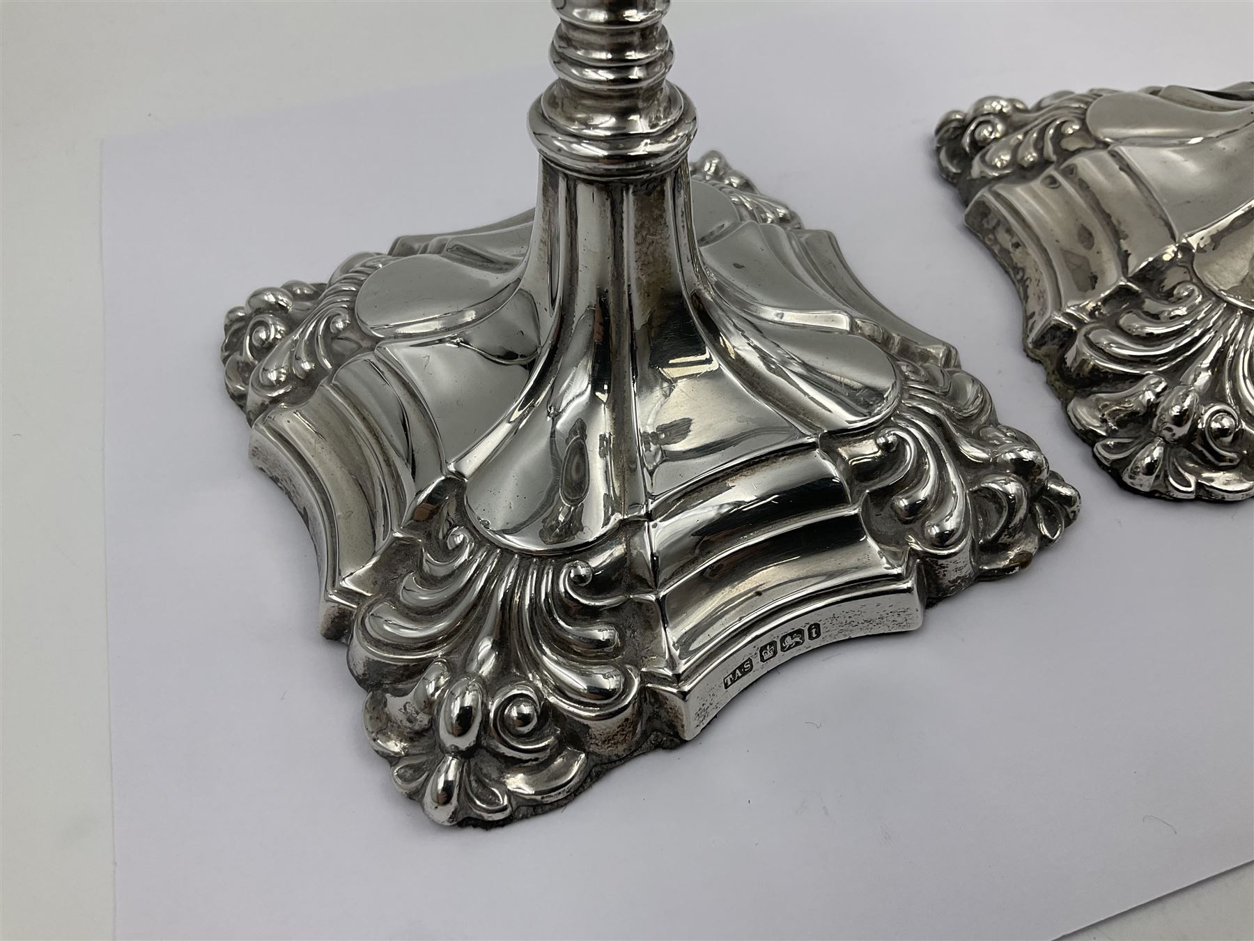 Pair of late Victorian silver mounted candlesticks, each of knopped and part fluted form, upon square stepped base with anthemions to each corner, with conforming sconces, hallmarked to removable sconces and foot, Thomas A Scott, Sheffield 1901, H25.2cm