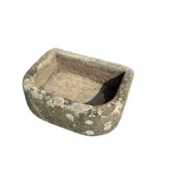 19th century hewn sandstone trough of D shaped form, in weathered finish