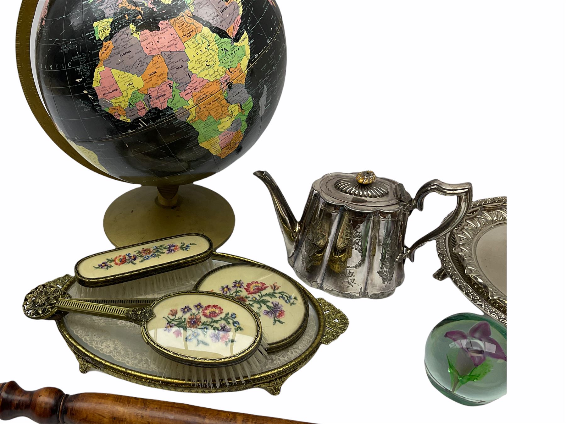 ladies vanity set with floral embroidery backs, comprising mirror, two brushes, comb and tray, along with paperweight with internal floral design, brass and copper bedwarmer, two metal serving trays, a metal teapot and a globe. 