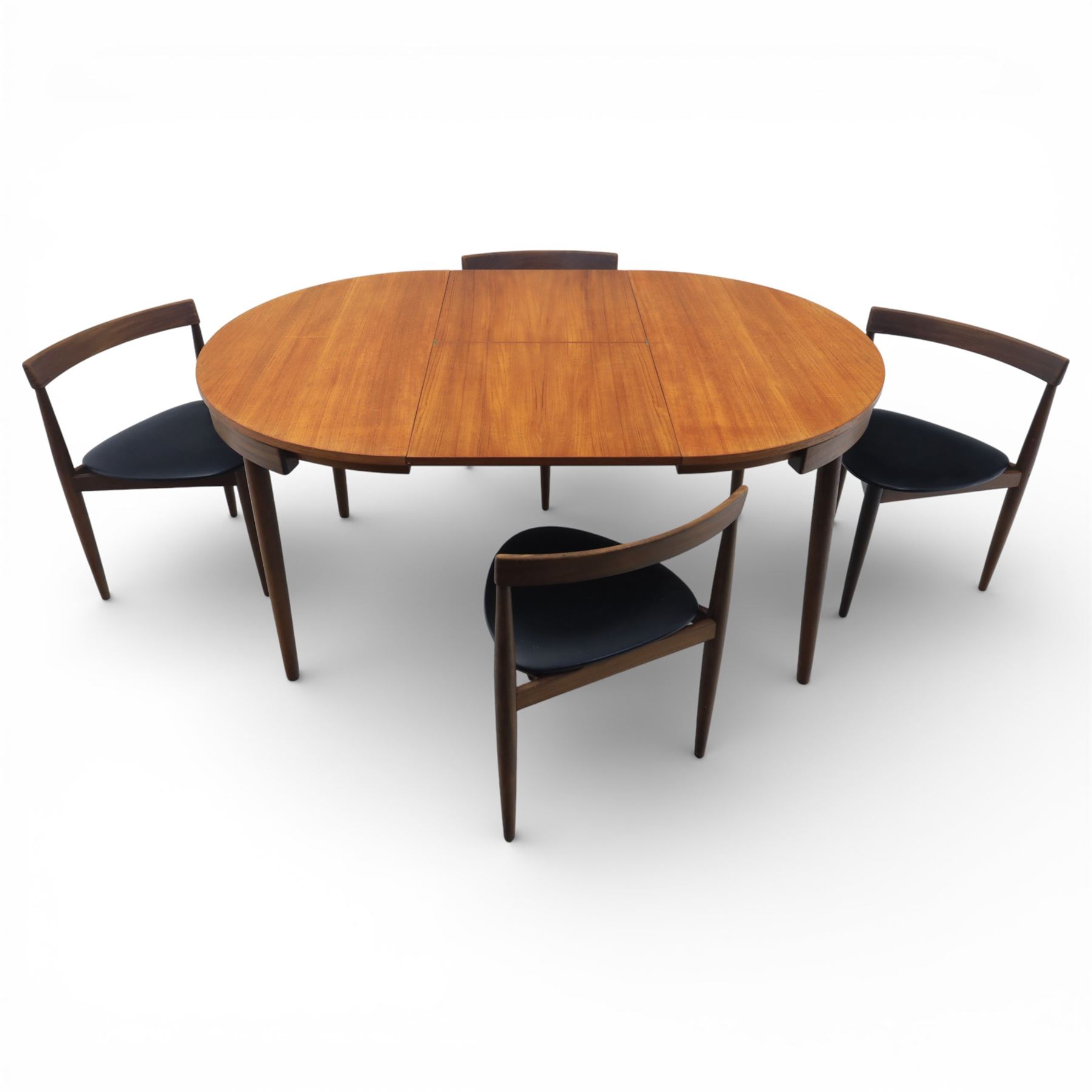 Frem Røjle - Danish teak 'Roundette' extendable dining table, circular top with softly chamfered edge and internal stowable leaf extends to 156cm, raised on four tapered cylindrical legs, accompanied by four matching dining chairs with shaped teak frames and black vinyl upholstered seats, the chairs designed to nest beneath the table when not in use