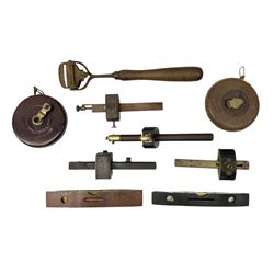Quantity of tools to include two leather cased tape measures, together with four mortice gauges, brass mounted spirit levels and cabinet box scraper plane