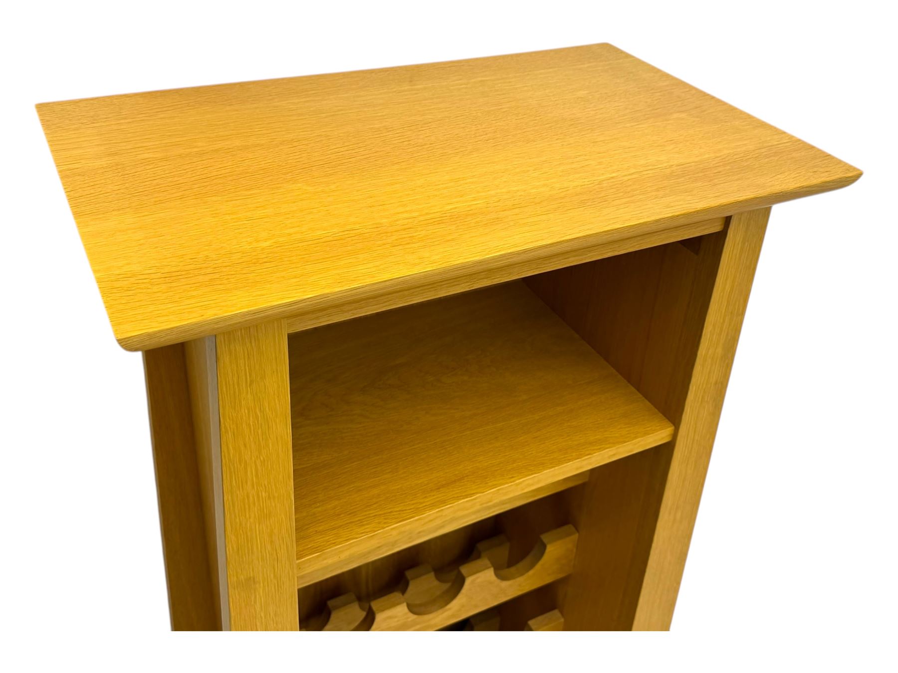 Contemporary light oak wine cabinet, rectangular overhanging top above an open shelf, fitted with four bottle racks each holding three bottles, single drawer with curved metal handle, on chamfered supports
