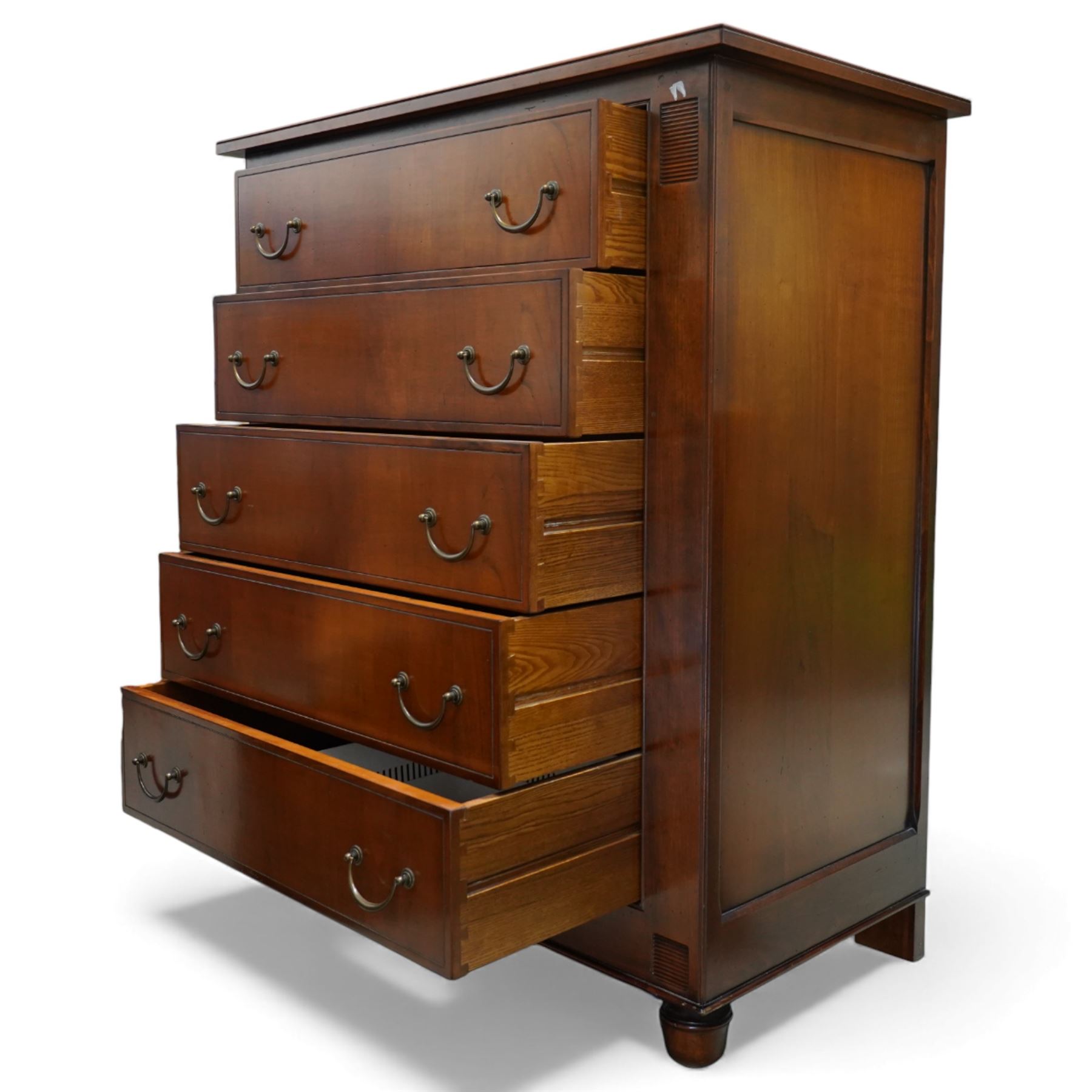 French cherry wood chest of drawers, rectangular moulded top above five long drawers with brass swing handles, flanked by reeded corner panels, raised on turned bun feet