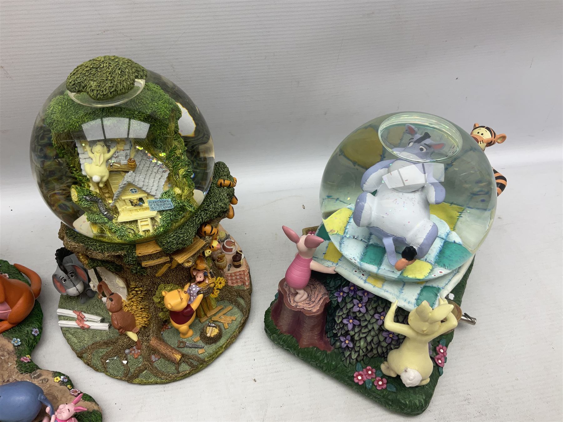 Five Disney Winnie The Pooh snow globes to include The Rain Rain Rain Came Down Down Down, Eeyore Pulling Cart, Owl's House, Rumbly in My Tumbly and Stuck In Rabbit's House, together with figure group with dome, five with boxes (6)
