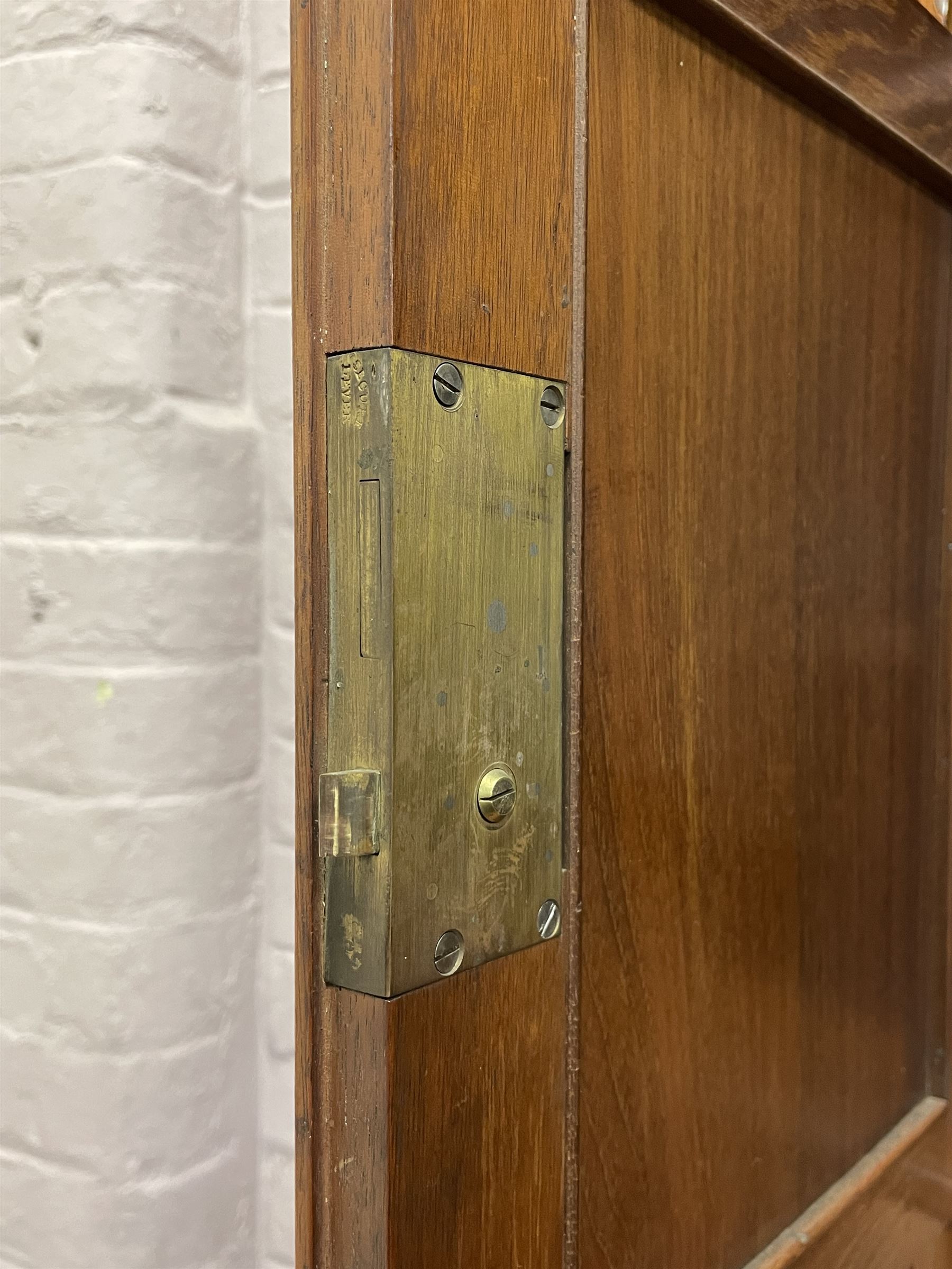 Late Victorian walnut dresser, the raised panelled back fitted with panelled cupboards, shelves and bevelled mirrors, moulded rectangular top over three drawers and cupboards, the left-hand cupboard fitted with two slides and the right-hand cupboard fitted with revolving drinks stand, on turned feet