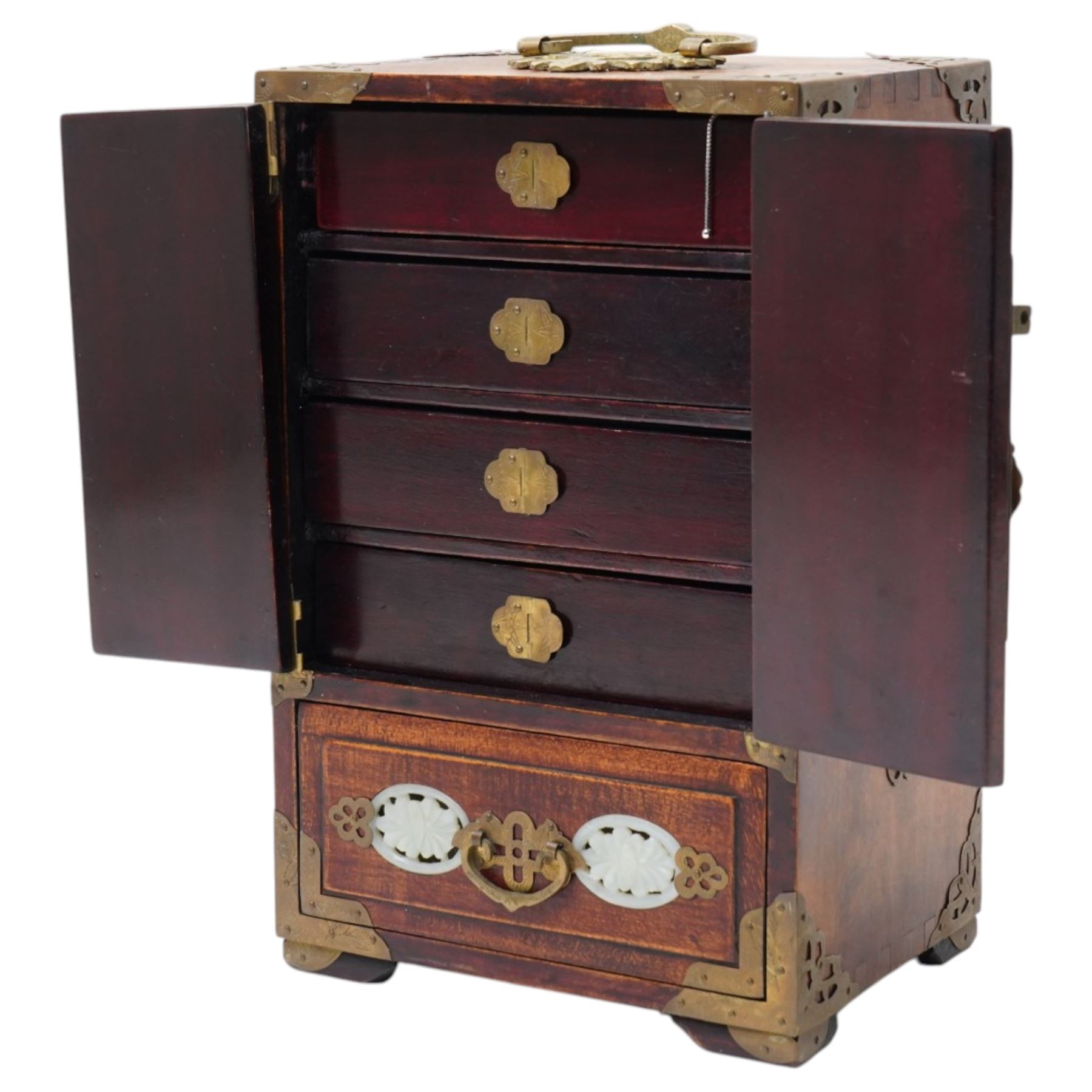 Chinese tabletop greenstone panelled cabinet, with brass mounts, feather pulls, revealing three fitted drawers, each with upholstered cushioned interior containing silver, polished stone and other costume jewellery