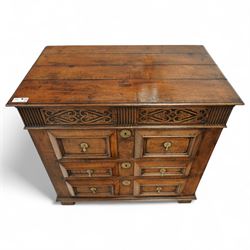 John Nethercott & Co - late 20th century hand-made oak 17th-century design chest of drawers, rectangular pegged and planked top above scrollwork carved frieze concealing two drawers, over three drawers, all with raised rectangular moulding and drop handles, raised on stile feet, the back with dated label for John Nethercott & Co