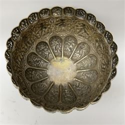 An Eastern white metal bowl, with pierced rim above a central embossed band of zoomorphic figures, and alternating lobed panels of animals and flowers, upon a circular spreading foot, H19cm D22cm. 