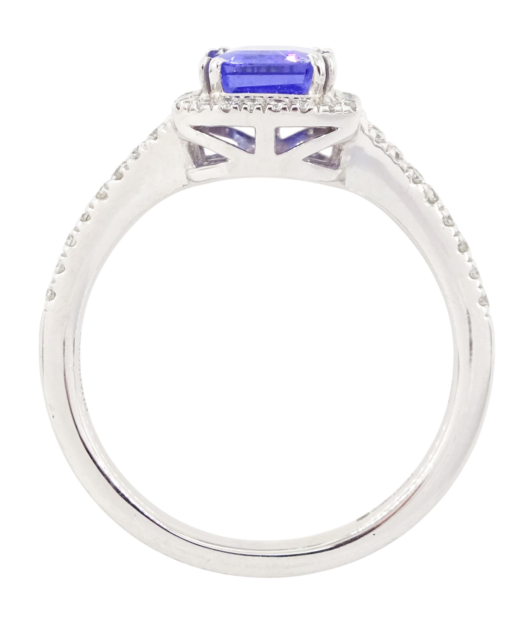 Platinum tanzanite and diamond cluster ring, single emerald cut tanzanite of approx 1.75 carat, with round brilliant cut diamond surround and split diamond set shoulders, signed Rhapsody, hallmarked, total diamond weight approx 0.20 carat