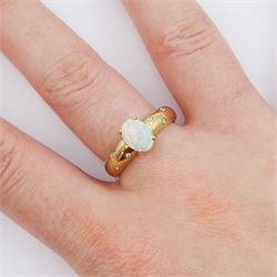 9ct gold opal ring, either side with three rubover set, round brilliant cut diamonds, Sheffield 2004