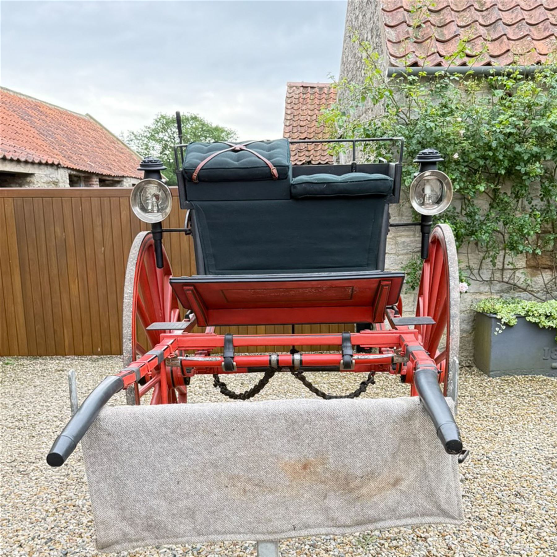 Holland & Holland Tandem Cart - Althorp Spencer Family Estate

A two wheeled tandem cart or cocking cart by Holland & Holland Coach Builders, London, with black painted bodywork, red painted shafts and running gear, red wooden spoked wheels with rubber tyres, green upholstered seating and a rear perforated metal footboard. The cart is fitted with carriage lamp brackets (lamps next lot), green buttoned cushions with leather retaining straps, side louvered body panels, footrests, leaf spring suspension and shafts for horse use. The carriage incorporates an adjustable body position, operated by a lever, allowing the body to be moved forwards or backwards to alter the weight distribution. Formerly owned by the family of Lady Diana Spencer,
Sympathetically conserved by Woods of Fairbourne Carriages Ltd, Kent.

Features:
• Brass maker’s plaque for Holland & Holland Coach Builders, London
• Two wheeled tandem cart
• Black painted body with red painted shafts and running gear
• Red wooden spoked wheels with rubber tyres
• Green upholstered cushions with leather retaining straps
• Adjustable carriage body for weight distribution
• Lever operated adjustment mechanism
• Perforated rear footboard
• Side footrests
• Louvered side panels
• Leaf spring suspension
• Rear opening storage compartment
• Decorative painted armorial motif to rear panel
• Fitted carriage lamps shown, not included in the lot (available as next lot)
• Conserved by Fairbourne Carriages Ltd
• Provenance: The Althorp Attic Sale including The Spencer Carriages, lot 195, 7 July 2010

Dimensions:
Overall length 396 / 198cm
Width 155cm
Height 190cm

Wheel Diameters:
Wheels: 148cm

Seating:
Driving seats: 2
Passenger seats: 2