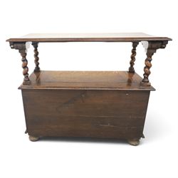 Early 20th century oak monks bench, panelled back converting to a table top, reeded armrests with barley twist uprights, hinged seat over panelled base supported on bun feet