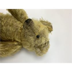 Early 20th century English teddy bear, WW1 period, with wood wool filled mohair body, fixed head with one boot button eye and vertically stitched nose and mouth and jointed limbs with cloth paw pads H16