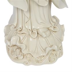 Large Chinese blanc de chine figure of Guanyin, depicting the goddess stood upon a lotus leaf with one hand raised, with potters seal mark to the reverse, H75cm