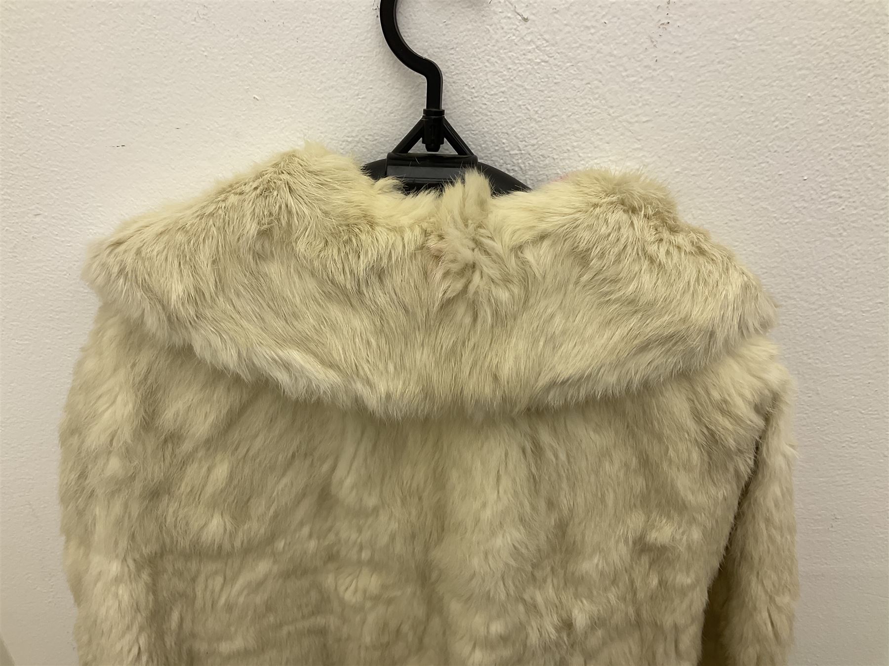 Brown mid length musquash fur coat by National Fur Company together with white rabbit cape
