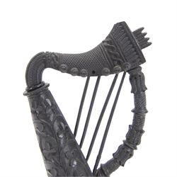 19th century Irish carved bog oak model of a harp, detailed with fluting, diamond cuts and shamrocks, upon a turned circular base, H29cm
