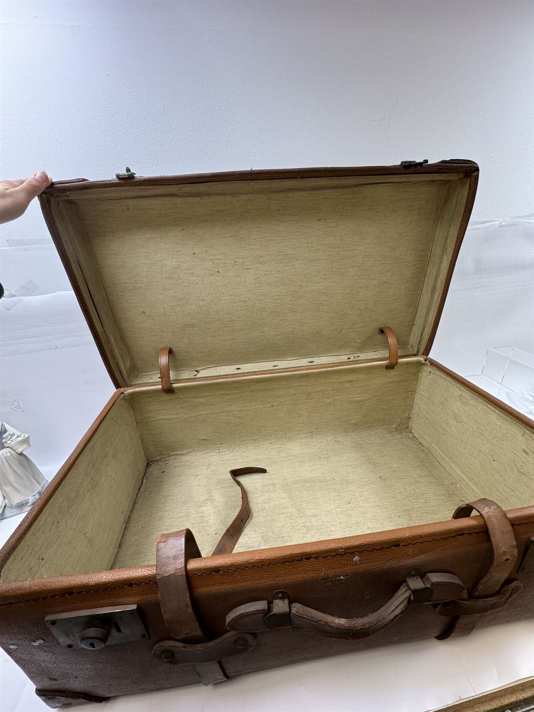 Early 20th century leather trunk, with brass fixtures, leather straps and buckle fastenings, embossed to the top with initials GG, H28cm, W76cm