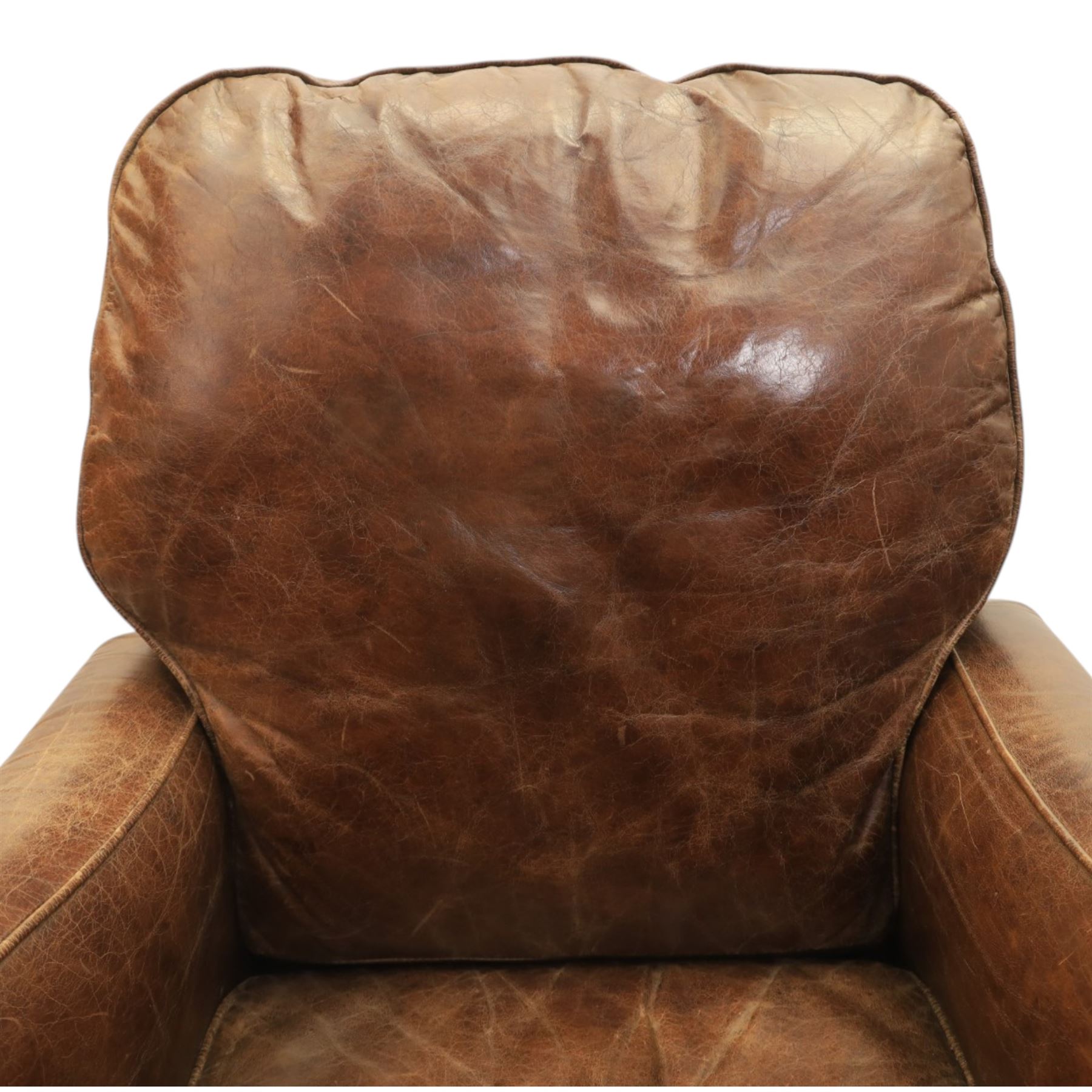 Art Deco style brown leather reclining armchair, scrolled arms with brass studded trim, reclining foot rest and back, fixed back and loose seat cushion,