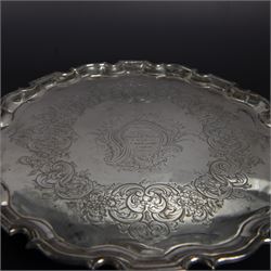 George II silver salver, of circular form with pie crust rim, with later floral and foliate decoration and presentation engraving to centre, upon three stepped feet, hallmarked William Peaston, London 1749, D30cm