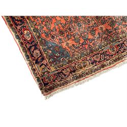 Persian Zanjan pale red ground rug, lozenge medallion and field decorated with floral Herati motifs, the border decorated with stylised plant motifs and trailing branches, floral pattern guard stripes