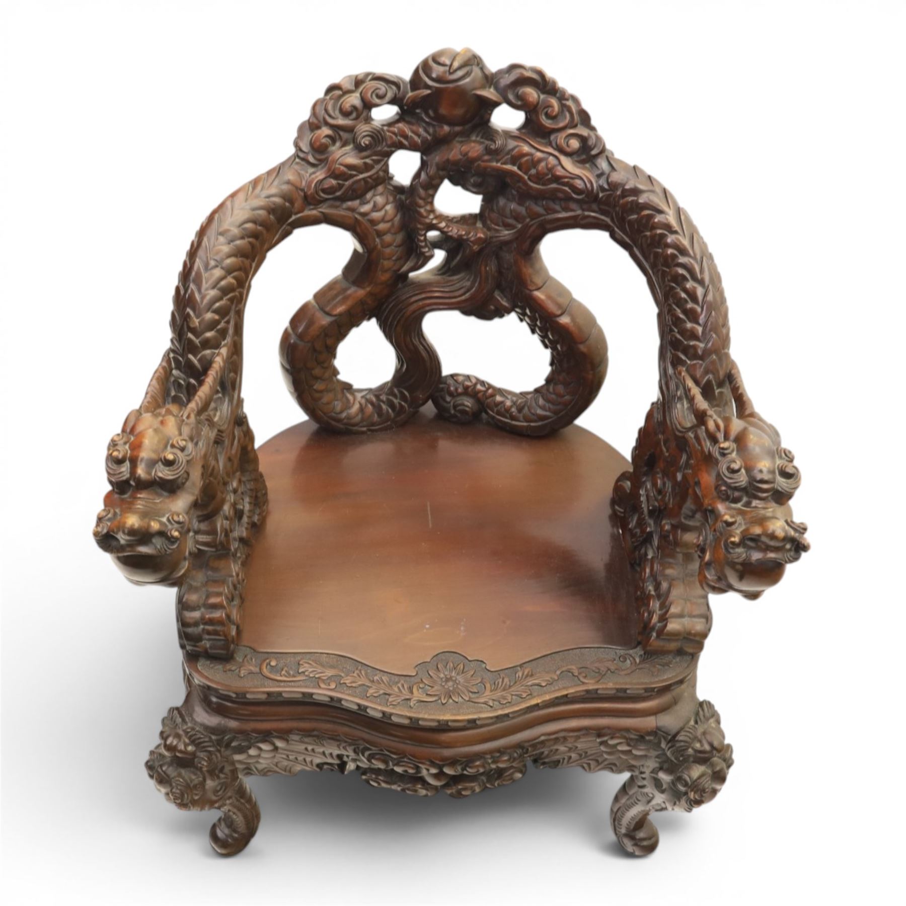 Chinese carved hardwood dragon throne chair, the shaped and pierced back with entwined dragons and cloud motifs, sweeping dragon-form arms terminating in carved heads, solid panel seat over foliate carved apron, on four mask carved cabriole supports