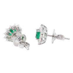 Pair of 18ct white gold round cut emerald and round brilliant cut diamond cluster stud earrings, stamped, total emerald weight approx 1.10 carat, total diamond weight approx 0.65 carat