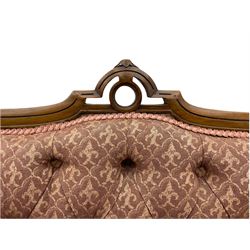 Victorian walnut settee, raised shaped back with pierced decoration, curved ends and buttoned back, upholstered in patterned fabric, turned and fluted front feet